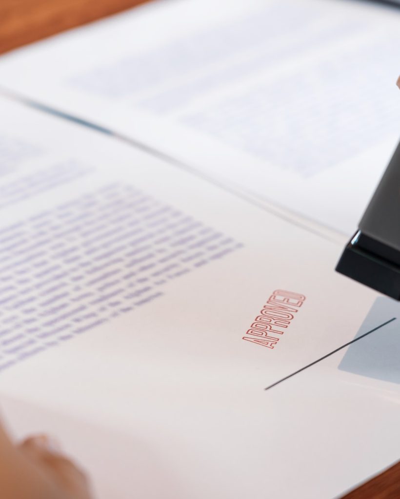 businessman-hand-notary-public-hand-ink-appoval-stamper-stamping-seal-on-approved-contract-form.jpg