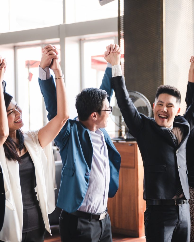 large-business-team-showing-unity-with-their-hands-together-business-team-celebrating.jpg
